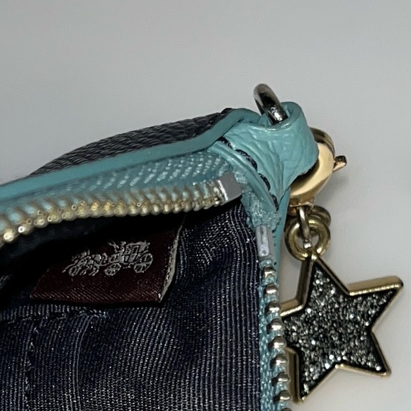 Stylish Coach wristlet in a deep dark blue color with a sleek design. - Picture 4 of 7